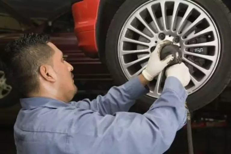 A picture of a a car tire being repair by West TX Auto Paint and Boat team